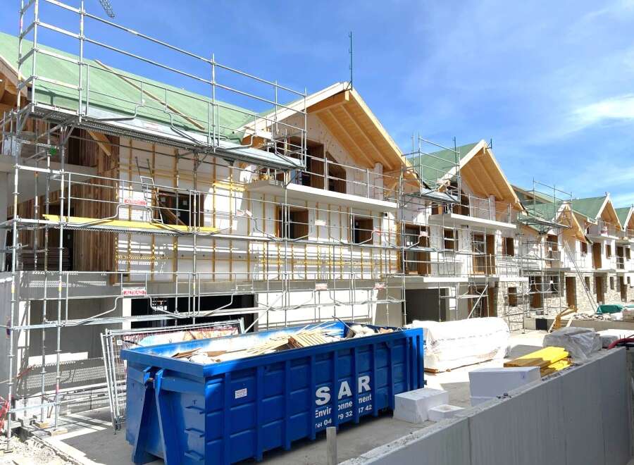 New construction homes are taking shape, showcasing modern architectural design.