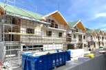 New construction homes are taking shape, showcasing modern architectural design.