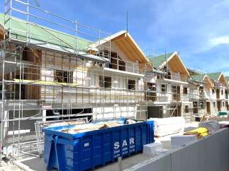 New construction homes are taking shape, showcasing modern architectural design.