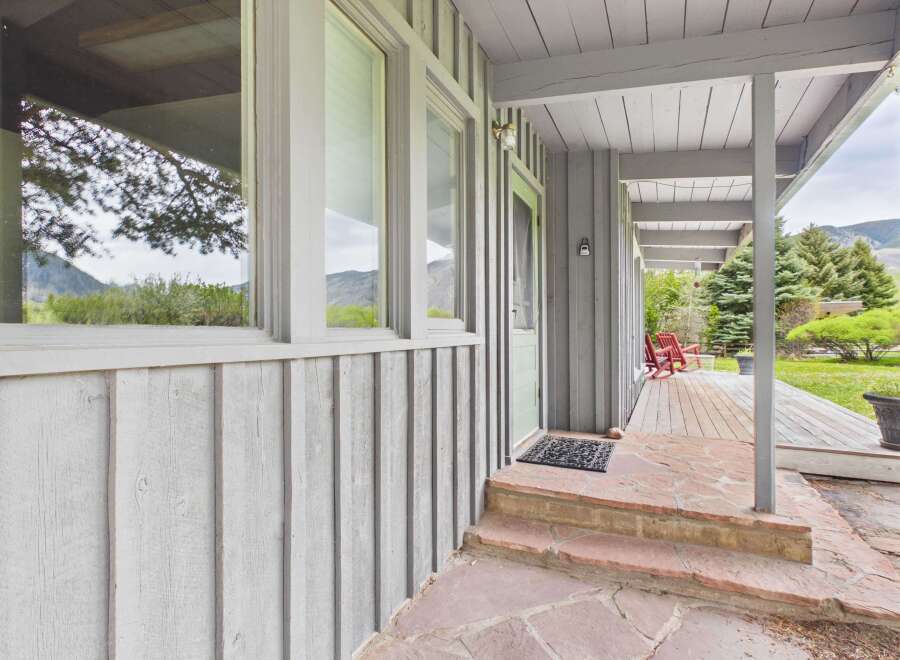 This charming property boasts a welcoming porch with a stone pathway, perfect for enjoying the outdoors.