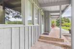 This charming property boasts a welcoming porch with a stone pathway, perfect for enjoying the outdoors.