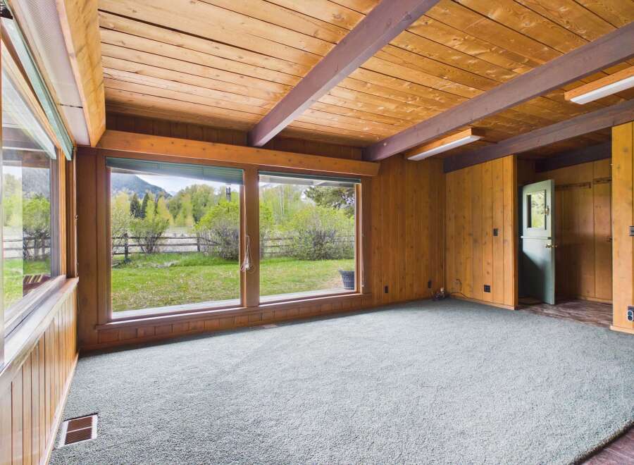Step into this inviting space, featuring a stunning view of the outdoors through expansive windows.