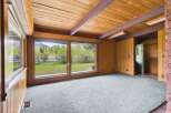 Step into this inviting space, featuring a stunning view of the outdoors through expansive windows.