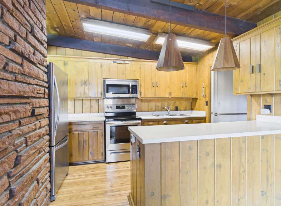 Step into this charming kitchen featuring a unique blend of rustic and modern elements.