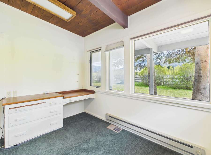 This charming room offers a serene retreat with its natural light and inviting ambiance.