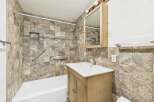 This bathroom features a stylish combination of functionality and design.