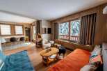 This cozy living space offers a warm and inviting atmosphere, perfect for relaxing after a day on the slopes.