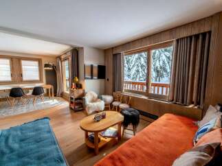 This cozy living space offers a warm and inviting atmosphere, perfect for relaxing after a day on the slopes.