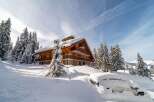 This stunning chalet, nestled in a snowy landscape, offers a perfect blend of rustic charm and modern comfort.