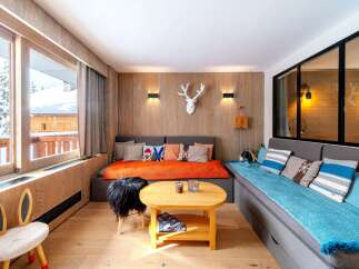 This cozy living space features a unique blend of rustic charm and modern comfort.