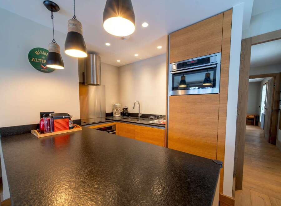 This modern kitchen boasts sleek design and functionality, perfect for culinary enthusiasts.