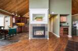 This stunning property boasts a cozy fireplace, perfect for those chilly evenings, complemented by beautiful hardwood floors that flow throughout the home.