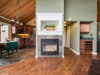 This stunning property boasts a cozy fireplace, perfect for those chilly evenings, complemented by beautiful hardwood floors that flow throughout the home.
