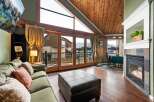 Experience luxury living in this stunning property, featuring a cozy fireplace and expansive windows that frame breathtaking mountain views.