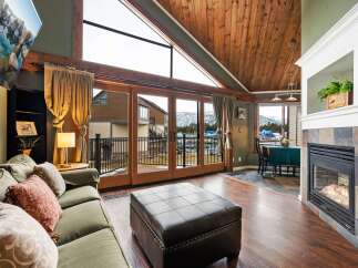 Experience luxury living in this stunning property, featuring a cozy fireplace and expansive windows that frame breathtaking mountain views.