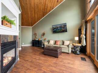Step into this inviting living space, featuring a cozy fireplace and a stylish, modern design.