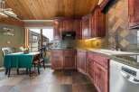 Step into this stunning kitchen, featuring rich, dark wood cabinetry and a unique tile backsplash.