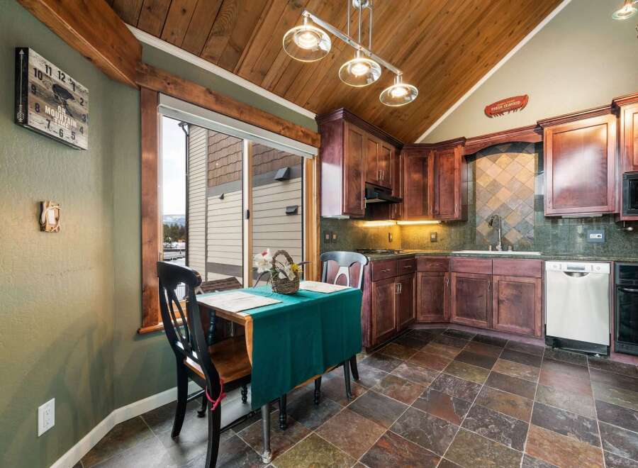 This charming kitchen boasts a warm and inviting atmosphere, perfect for culinary creations and casual dining.