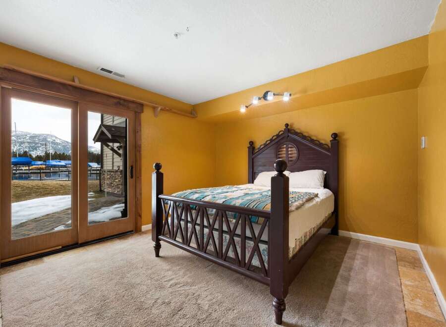 This stunning bedroom boasts a unique design with a beautiful wooden bed frame.