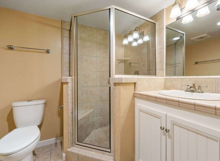 Step into this beautifully designed bathroom featuring a spacious shower with a glass enclosure.