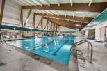 This indoor swimming pool offers a refreshing escape with its inviting blue waters and ample space for swimming and relaxation.