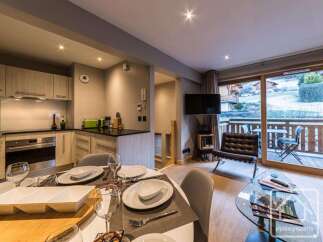 Experience luxury living in this stunning property, featuring a modern kitchen and a cozy dining area perfect for entertaining.