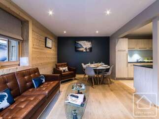 Experience luxury living in this stunning property, featuring a beautifully designed living area with a comfortable leather sofa and a stylish glass coffee table.