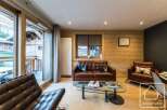 Discover the charm of this stunning property, featuring a cozy living room with a leather sofa and armchairs.