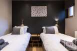 This cozy bedroom features two twin beds, perfect for a comfortable stay.