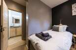 Discover the charm of this cozy bedroom, featuring a comfortable bed and a stylish design.