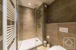 Step into this modern bathroom featuring a sleek glass shower enclosure and stylish tile work.
