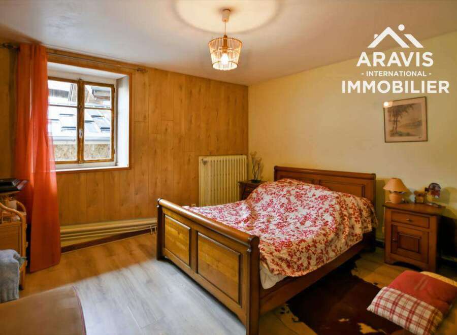 Discover the charm of this inviting bedroom, featuring warm wooden accents and a cozy atmosphere.