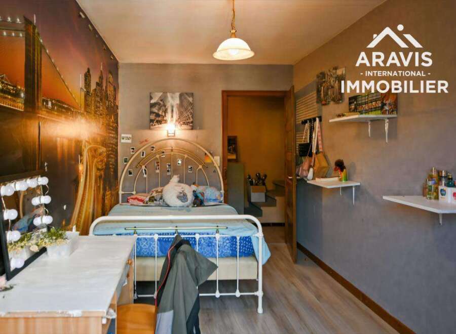 Discover this charming bedroom featuring a unique cityscape mural that adds a touch of urban elegance.