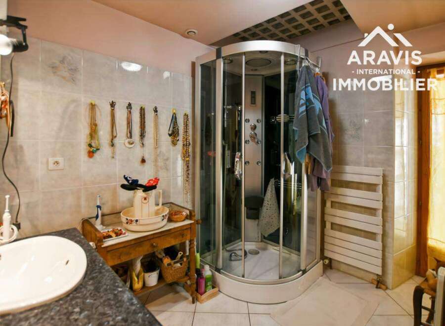 Discover this charming bathroom featuring a modern shower cabin, perfect for a relaxing experience.