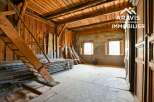 Discover the rustic charm of this unique property, featuring exposed wooden beams and a spacious interior.