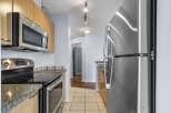 Step into this modern kitchen, featuring sleek stainless steel appliances and ample counter space.