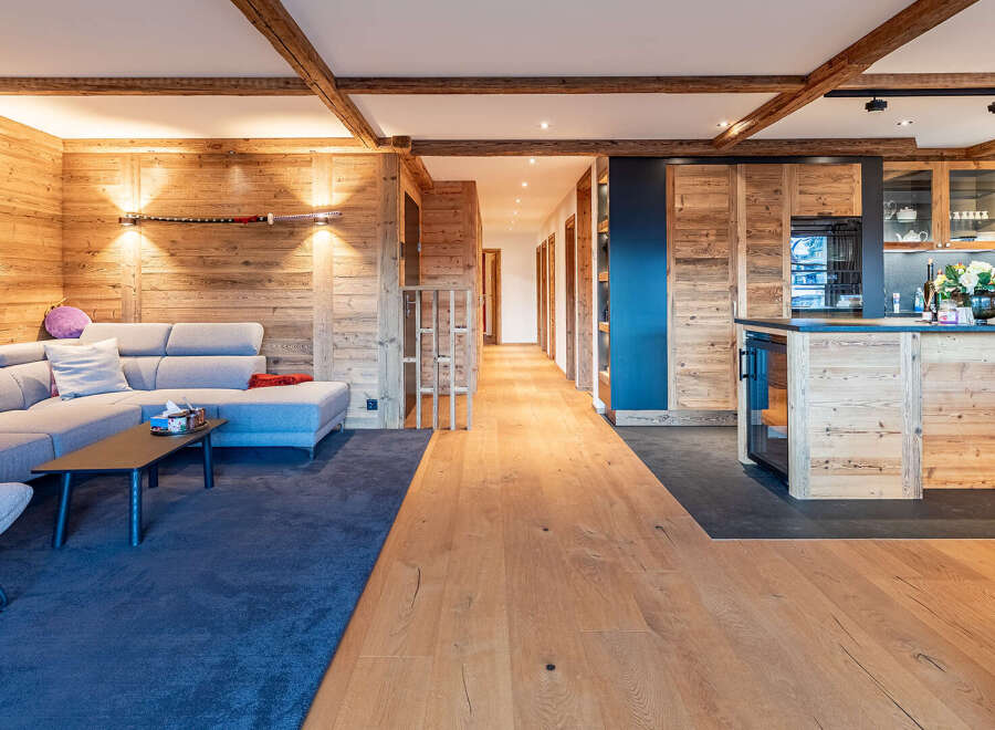 Experience the warmth of this stunning property, featuring exquisite wood paneling and exposed beams throughout.
