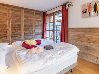 This charming bedroom boasts rustic wooden accents, creating a warm and inviting atmosphere.