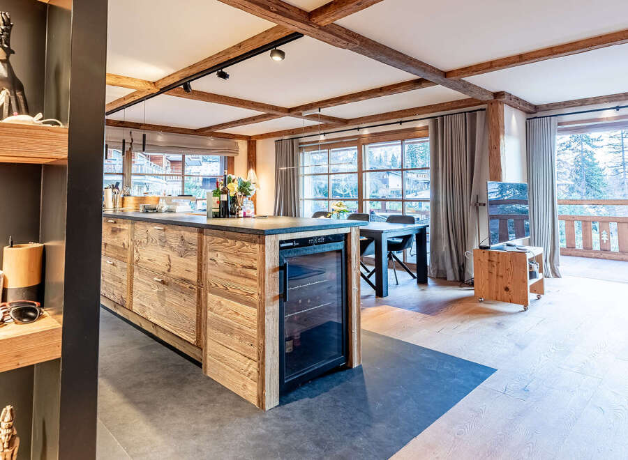 This stunning property boasts a modern kitchen with a wine fridge, perfect for entertaining.