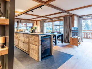 This stunning property boasts a modern kitchen with a wine fridge, perfect for entertaining.