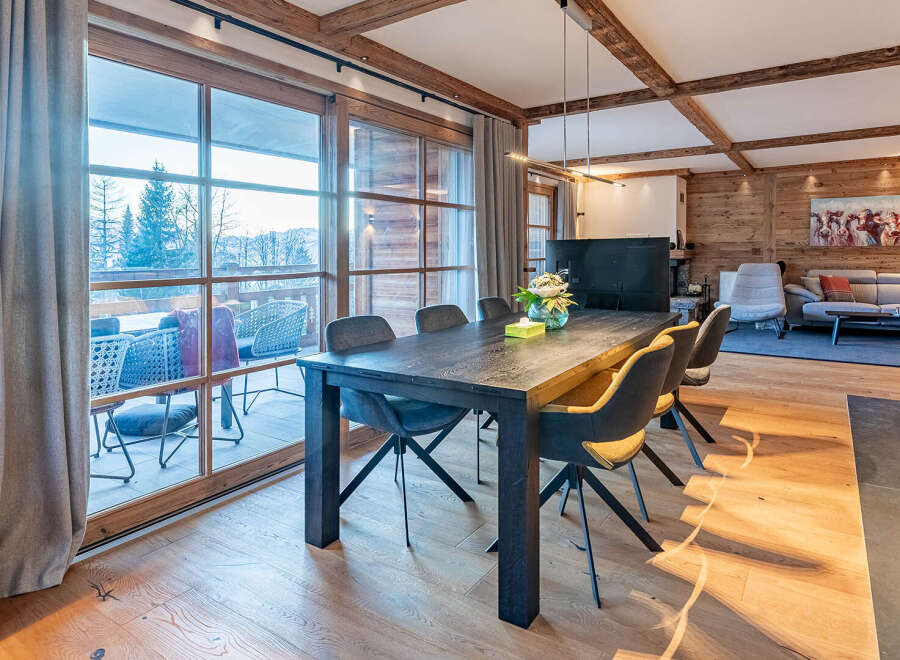Experience luxury living in this stunning property featuring a spacious dining area with a modern table and stylish chairs.