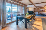 Experience luxury living in this stunning property featuring a spacious dining area with a modern table and stylish chairs.