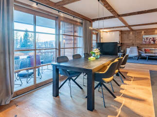 Experience luxury living in this stunning property featuring a spacious dining area with a modern table and stylish chairs.