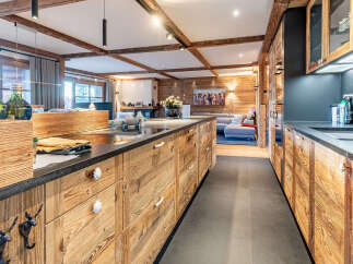 This stunning kitchen showcases a rustic design with wooden cabinetry and a sleek countertop, creating a warm and inviting atmosphere.