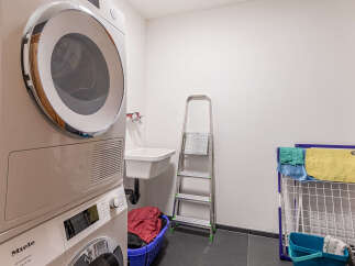 This laundry room offers a functional and organized space for all your washing needs.