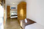 This cozy bedroom features a comfortable bed and ample storage space.