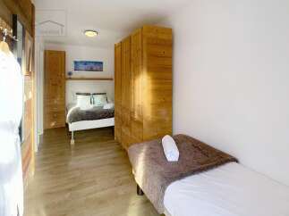 This cozy bedroom features a comfortable bed and ample storage space.