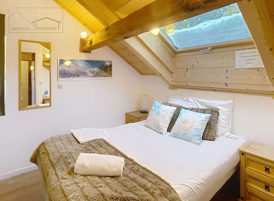 Discover the charm of this cozy bedroom, featuring a comfortable bed with plush bedding and decorative pillows.