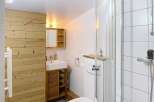 Discover this charming bathroom featuring a modern shower, a sleek toilet, and a stylish vanity.