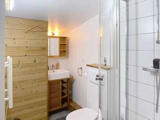 Discover this charming bathroom featuring a modern shower, a sleek toilet, and a stylish vanity.